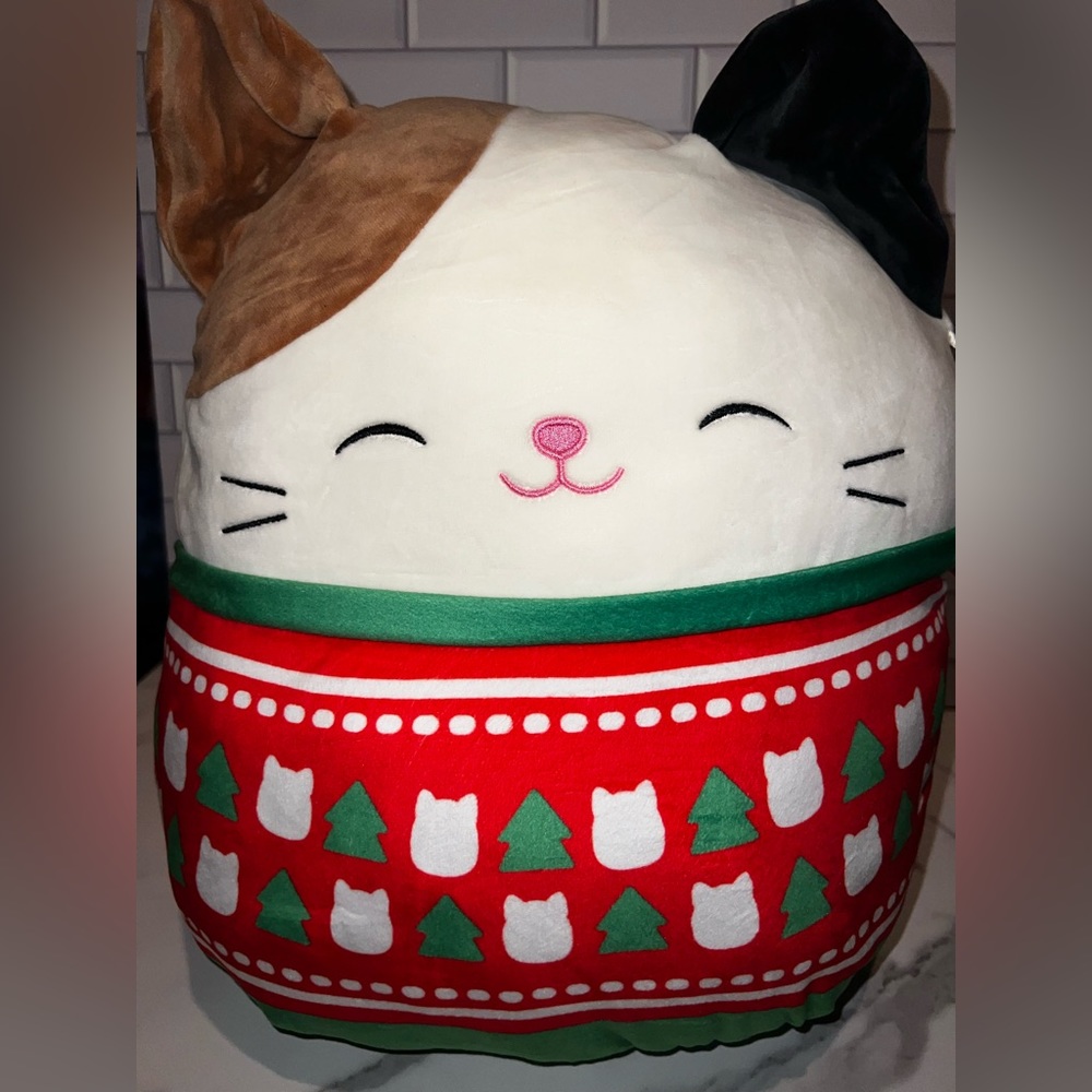 Squishmallows Cam the Cat wearing a Xmas Sweater